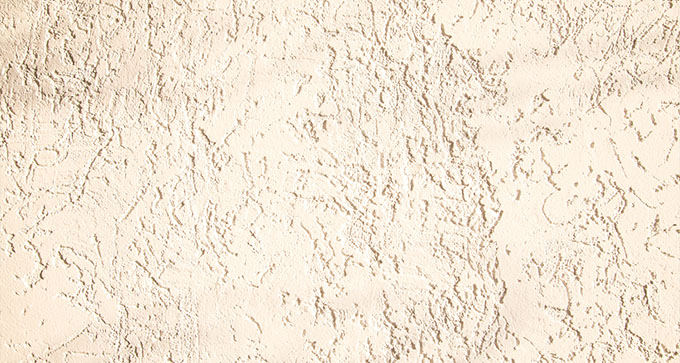 textured beige wall surface with subtle patterns and shadows